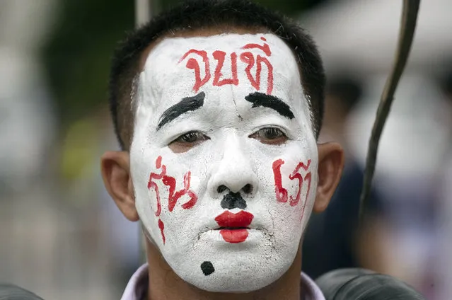 A pro-democracy demonstrator with a face paint that reads “End it with our generation” during a protest at Thammasat University in Pathum Thani, north of Bangkok, Thailand, Monday, August 10, 2020. Protesters warned that they'll step up pressure on the government if it failed to meet their demands, which include dissolving the parliament, holding new elections and changing the constitution. (Photo by Sakchai Lalit/AP Photo)