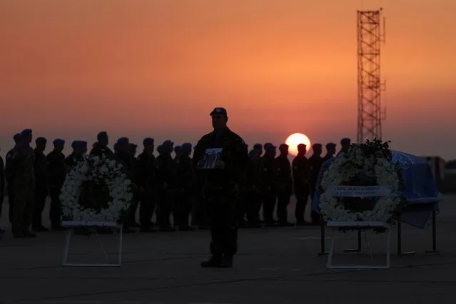 Members of the United Nations Interim Force in Lebanon (UNIFIL) peacekeeping mission attend the repatriation ceremony for Irish soldier Sean Rooney who was killed on a U.N. peacekeeping patrol, at Beirut International Airport, in Beirut, Lebanon on December 18, 2022. (Photo by Mohamed Azakir/Reuters)