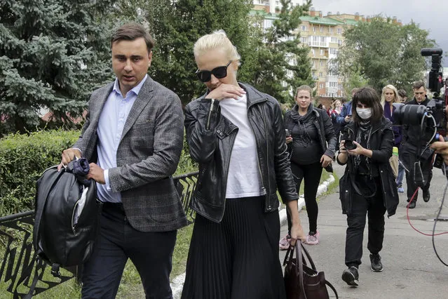 Alexei Navalny's wife Yulia, center, and Navalny's colleague Ivan Zhdanov, left, arrive to the Omsk Ambulance Hospital No. 1, intensive care unit where Alexei Navalny was hospitalized in Omsk, Russia, Friday, August 21, 2020. Russian doctors treating opposition leader Alexei Navalny say they don't believe he was poisoned and refused to transfer him to a German hospital. (Photo by Evgeniy Sofiychuk/AP Photo)