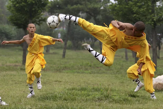 Shaolin students play soccer at Tagou Wushu School in Zhengzhou, Henan province. (Photo by Donald Chan/Reuters)