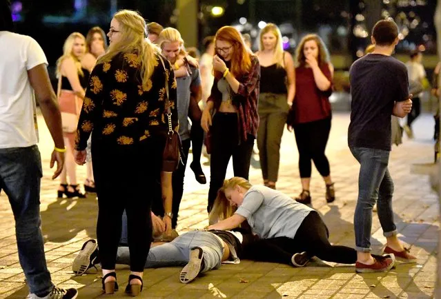 Giggles all round as a Portsmouth reveller falls over, presumably from too much to drink, as a friend tries to rally them to get up in Portsmouth, Hampshire on September 21, 2016. (Photo by Paul Jacobs/PictureExclusive.com)