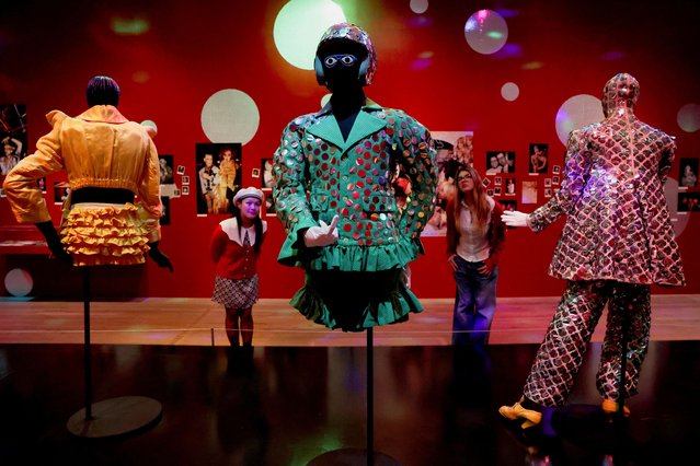 Staff members pose next to garments on display during a photocall for an exhibition showcasing Leigh Bowery's collection of costumes at the Tate Modern in London, Britain on February 25, 2025. (Photo by Temilade Adelaja/Reuters)