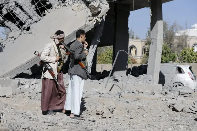 Houthi militants stand at the site of Saudi-led air strikes in Yemen's capital Sanaa October 28, 2015. (Photo by Khaled Abdullah/Reuters)