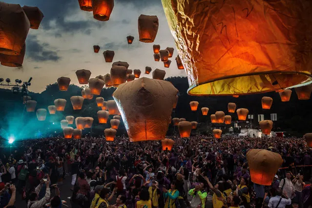 Tourists release sky lantern during the Pingxi lantern festival on March 2, 2018 in Pingxi, Taiwan. Pingxi, a Taiwanese district known for its old train tracks and lantern launchings, hosts the Pingxi Sky Lantern Festival annually to celebrate the last day of the Lunar New Year by releasing thousands of lanterns which each carrying its flame into the night. The former coal-mining town is lined with workshops which helps visitors build lanterns with paper and glue but critics have said the event is has become unsustainable and angered the locals as up to 600,000 half-burnt lanterns crashes back to earth into surrounding mountains. Sky lanterns were invented in ancient China between AD 220-265 by military strategist Zhuge Liang to transmit information and first introduced in Taiwan in the 19th century. They were originally released as prayers for the coming year at the beginning of the spring planting season but due to xxx, Taiwanese government has only allowed the release of sky lanterns in the rural district. (Photo by Billy H.C. Kwok/Getty Images)