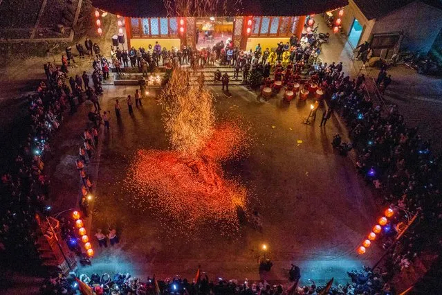 This photo taken on March 1, 2023 shows a man putting on a performce with fire amid a show rooted in ancient traditions to ward off bad luck and to bring along good fortune in Pan'An County, Jinhua city, in China's eastern Zhejiang province. (Photo by AFP Photo/China Stringer Network)