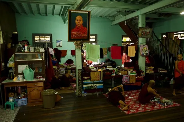 Buddhist monks rest at their dormitory which is decorated with a portrait of firebrand monk Wirathu inside the Masoyein monastery complex in Mandalay October 7, 2015. (Photo by Jorge Silva/Reuters)