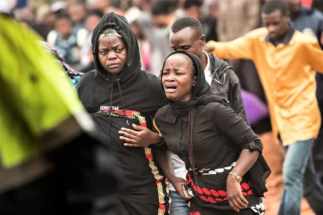 A woman is overcome by grief as she attends the burial ceremony of some of the people who lost their lives following heavy rains caused by Cyclone Freddy, in Blantyre, southern Malawi, Wednesday, March 15, 2023. (Photo by Thoko Chikondi/AP Photo)