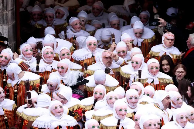 Revellers dressed as a “Gilles”, the oldest and principal participants in the Carnival of Binche in Belgium, take part in the parade in Binche on February 21, 2023. (Photo by Kenzo Tribouillard/AFP Photo)