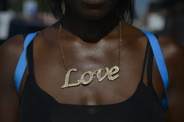 Ahmesha Ross, 23, of St. Louis, sports her new “Love” necklace outside Friendly Temple Missionary Baptist Church before the funeral of Michael Brown on Monday, August 25, 2014, in St. Louis, MO. Michael Brown, an 18-year-old African American male, was fatally gunned down by a White police officer, Darren Wilson, on August 9 in Ferguson, MO.  Ross said the necklace “represents me. I'm a loving woman. (Photo by Jahi Chikwendiu/The Washington Post)