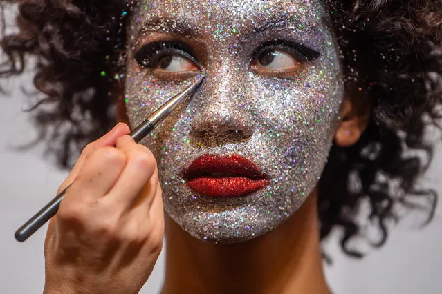 A model has her make-up prepared for a show of an Autumn/Winter 22/23 collection at the Budapest Central European Fashion Week  (BCEFW), in Budapest, Hungary, 06 February 2022. The BCEFW, that started on 31 January, will run until 06 February 2022. (Photo by Zoltan Balogh/EPA/EFE)