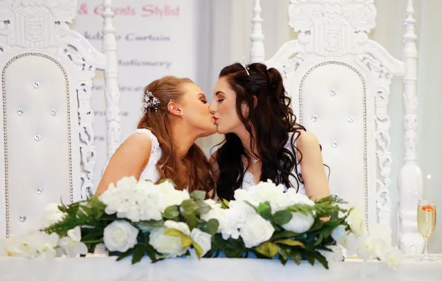 Sharni Edwards, 27, and Robyn Peoples, 26, a Belfast couple who are the first known same-s*x couple to get married in Northern Ireland, kiss after being married, in Carrickfergus, Northern Ireland on February 11, 2020. (Photo by Phil Noble/Reuters)