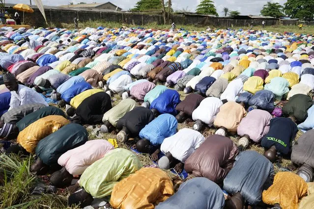 Nigerian Muslims pray in an open ground field during the Eid al-Fitr prayers in Lagos, Nigeria, Friday, April 21, 2023. Muslims around the world celebrate the end of the holy month of Ramadan. (Photo by Sunday Alamba/AP Photo)