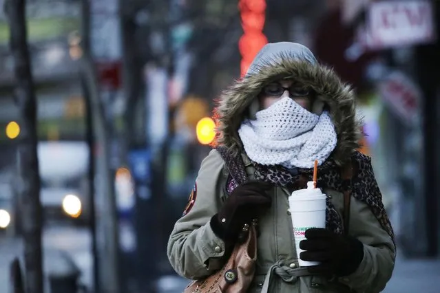 A woman carries a beverage in a plastic foam cup, Thursday, January 8, 2015 in New York. Nearly two years after former Mayor Michael Bloomberg suggested banning foam food containers, Mayor Bill de Blasio is expected to announce the ban is a reality. (Photo by Mark Lennihan/AP Photo)