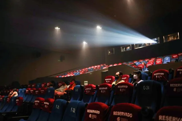 People wearing protective face masks are seen inside the movie theater “Cineteca Nacional” as cinemas, gyms and museums are gradually reopened after the city government eased isolation measures introduced to prevent the spread of the coronavirus disease (COVID-19), in Mexico City, Mexico on March 1, 2021. (Photo by Henry Romero/Reuters)