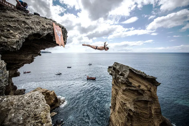 In this handout image provided by Red Bull, Alessandro De Rose of Italy dives from a 25 metre cliff at the Snakehead on Islet Vila Franco do Campo during the first training session of the third stop of the Red Bull Cliff Diving World Series on July 12, 2018 at Sao Miguel, Azores, Portugal. (Photo by Romina Amato/Red Bull via Getty Images)