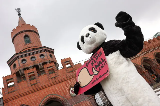 A person dressed as a panda holds a sign that reads “For a climate election 2021!” during a protest of Fridays for Future activists calling for a “Global Day of Climate Action”, as the spread of the coronavirus disease (COVID-19) continues, in Berlin, Germany, March 19, 2021. (Photo by Christian Mang/Reuters)