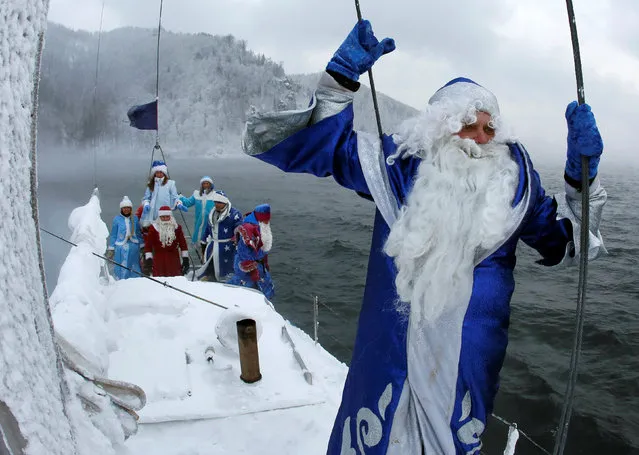 Members of the “Skipper” yacht club dressed as Ded Moroz, the Russian equivalent of Santa Claus, and his granddaughter Snegurochka (Snow Maiden) sail a yacht along the Yenisei River while marking the end of the sailboat season, with the air temperature at about minus 21 degrees Celsius (minus 5.8 degrees Fahrenheit), outside the Siberian city of Krasnoyarsk, Russia, November 21, 2016. (Photo by Ilya Naymushin/Reuters)