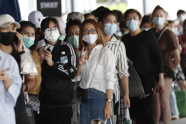 Workers in a local entertainment venue area line up for the coronavirus test in Bangkok, Thailand, Thursday, April 8, 2021. Thailand has confirmed its first local cases of the coronavirus variant first detected in the U.K., raising the likelihood that it is facing a new wave of the pandemic, a senior doctor said Wednesday. (Photo by Sakchai Lalit/AP Photo)
