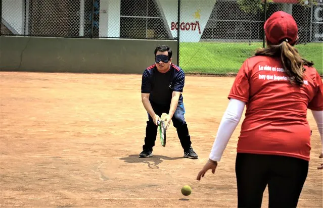 Visually impaired athletes of Blind Tennis Foundation (Fundacion Pasion por el Tenis) play tennis during a practice session in Bogota, Colombia on July 26, 2023. The foundation is dedicated to prepare children, youth, adults, blind people, and people with irreversible low vision for the International Blind Sports Federation (IBSA) World Games in Birmingham, the largest international high-level event for visually impaired athletes, with more than 1,250 competitors from 70 countries. (Photo by Juancho Torres/Anadolu Agency via Getty Images)