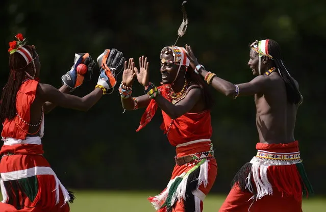 Nissan Jonathan Ole Meshami (C) of the Maasai Cricket Warriors team from Kenya is congratulated after a dismissal by teammates in a match against English team “The Shed” during “The Last Man Stands” cricket tournament at Dulwich sports ground in South London September 1, 2013. (Photo by Philip Brown/Reuters)
