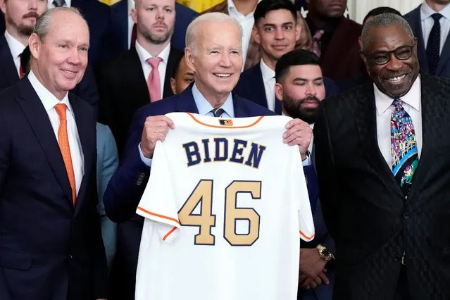 Houston Astros owner Jim Crane and Houston Astros manager Dusty Baker Jr., right, present a jersey to President Joe Biden during an event celebrating the 2022 World Series champion Houston Astros baseball team, in the East Room of the White House, Monday, August 7, 2023, in Washington. (Photo by Jacquelyn Martin/AP Photo)