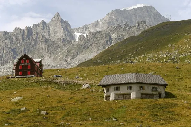A machine-gun bunker, part of a former Swiss artillery fortress called Fuchsegg, is camouflaged as a stable beside the Furka mountain-pass road near the village of Realp, Switzerland August 6, 2015. Fuchsegg fortress, located in the central Swiss Alps, was built in 1943 and remained in military use until 1993. With the threat of foreign invasion a thing of the past, thousands of military bunkers and fortresses in Switzerland have been put to commercial use, from hotels to data centres, museums to cheese factories. (Photo by Arnd Wiegmann/Reuters)