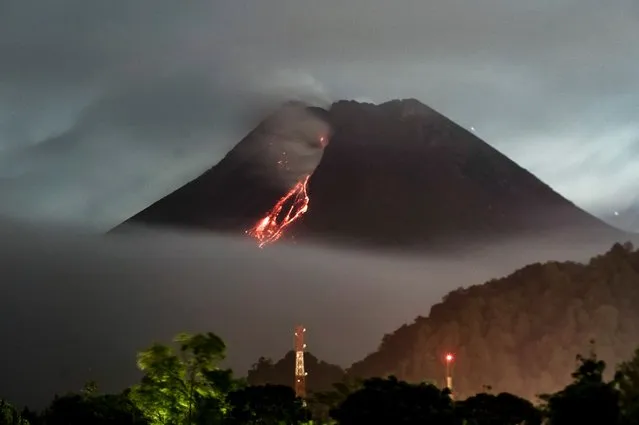 Lava flows down from the crater of Mount Merapi, Indonesias most active volcano, as seen from Kaliurang in Yogyakarta on April 14, 2021. (Photo by Agung Supriyanto/AFP Photo)