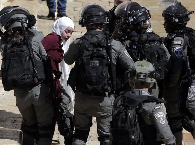 Israeli police arrests a Palestinian woman during clashes between Israeli security forces and Palestinian protesters in Jerusalem's Old City, Tuesday, May 18, 2021. (Photo by Mahmoud Illean/AP Photo)