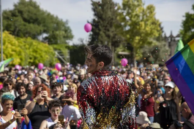Participants dance in the annual Gay Pride parade in Jerusalem, Thursday, June 3, 2021. Thousands of people marched through the streets of Jerusalem on Thursday in the city's annual gay pride parade. (Photo by Ariel Schalit/AP Photo)