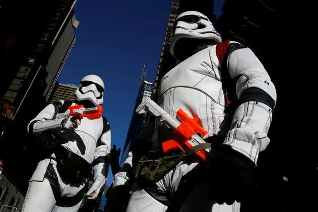 People dressed as Stormtroopers from Star Wars Rogue One walk in Times Square on Christmas Day in Manhattan, New York City, U.S., December 25, 2016. (Photo by Andrew Kelly/Reuters)