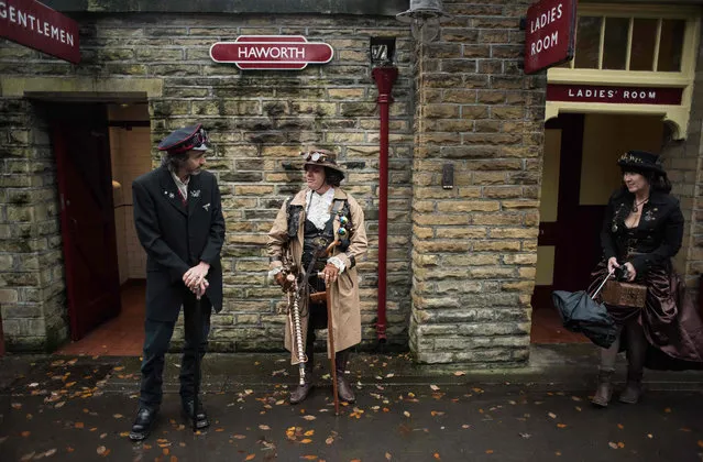 Steampunk enthusiasts wait for a steam train at Haworth station as they attend the sixth annual Haworth Steampunk Weekend in Haworth, northern England on November 25, 2018. (Photo by Oli Scarff/AFP Photo)