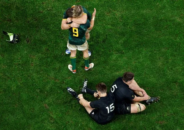 South Africa's Faf de Klerk celebrates after winning the Rugby World Cup final as New Zealand's Beauden Barrett and Scott Barrett look dejected, at the Stade de France in Saint Denis, France on October 28, 2023. (Photo by Peter Cziborra/Reuters)