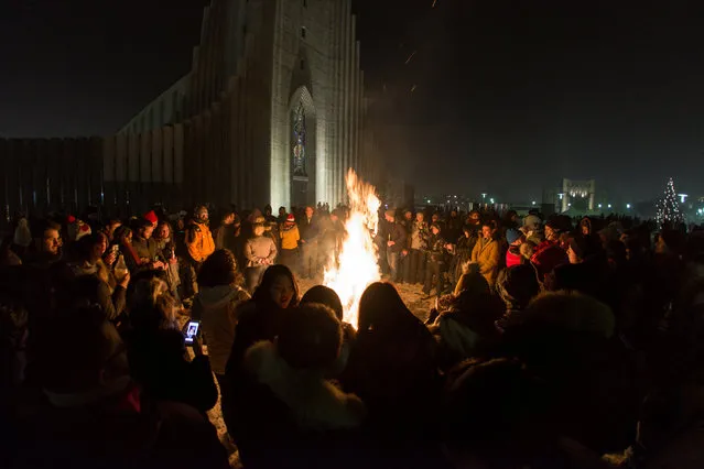 People gather at Hallgrims church to celebrate the New Year in Reykjavik, Iceland, January 1, 2017. (Photo by Reuters/Geirix)