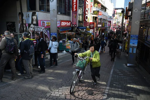 People make their way along a street in the Harajuku area on Friday November 04, 2016 in Tokyo, Japan. (Photo by Matt McClain/The Washington Post)