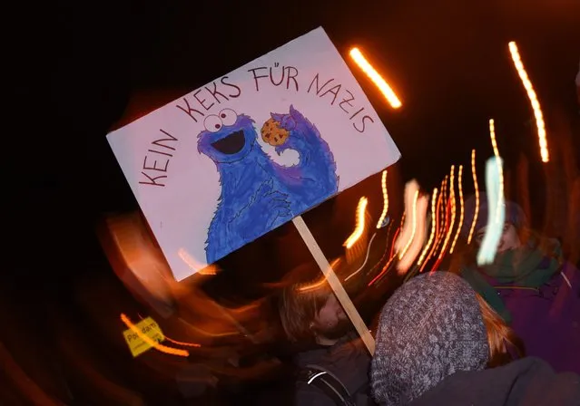 Demonstrators carry a poster with the inscription “No cookies for Nazis”, during a counter-demonstrations rally in Bergholz-Rehbruecke, near Potsdam, Brandenburg, Germany, 10 February 2016. The fifth Pogida-parade takes place in Potsdam with several counter-demonstrations. (Photo by Ralf Hirschberger/EPA)