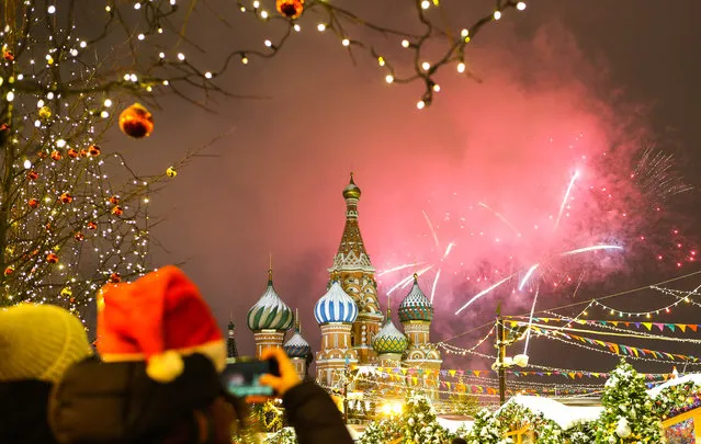 Fireworks go off over Red Square, Moscow, Russia on January 1, 2019. (Photo by TASS/Barcroft Images)