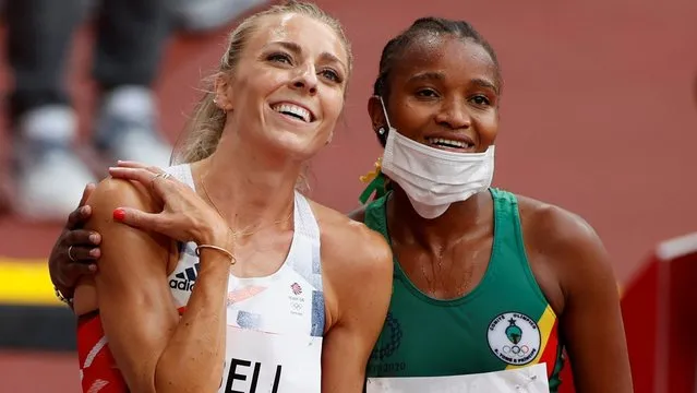 Britain's Alexandra Bell (L) and Sao Tome and Principe's D'Jamila Tavares react after competing in the women's 800m heats during the Tokyo 2020 Olympic Games at the Olympic Stadium in Tokyo on July 30, 2021. (Photo by Phil Noble/Reuters)