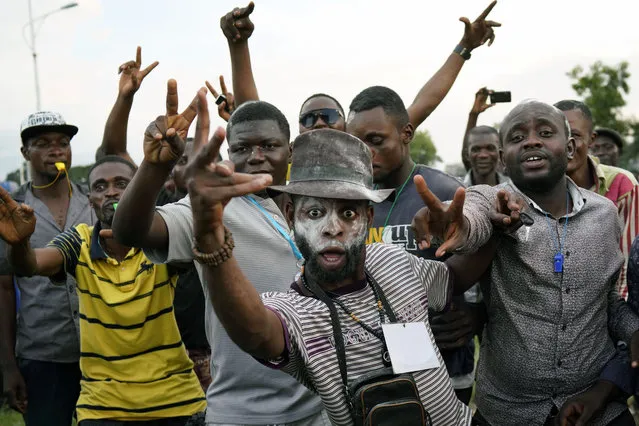 Supporters of opposition presidential candidate Felix Tshisekedi party outside his headquarters as they wait for election results to be released in Kinshasa, Congo, Wednesday January 9, 2019. As Congo anxiously awaits the outcome of the presidential election, many in the capital say they are convinced that the opposition won and that the delay in announcing results is allowing manipulation in favor of the ruling party. (Photo by Jerome Delay/AP Photo)