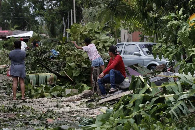 Locals remove debris from their homes after the passage of Hurricane Grace, in Tulum, Quintana Roo state, Mexico, on Thursday, August 19, 2021. The Category 1 storm made landfall at 4:45 am, just south of the ancient Mayan temples of Tulum, hitting the Caribbean coast with heavy rain and causing a dangerous storm surge. (Photo by Marco Ugarte/AP Photo)