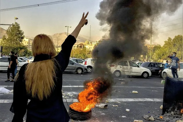 In this photo taken by an individual not employed by the Associated Press and obtained by the AP outside Iran, Iranians protests the death of 22-year-old Mahsa Amini after she was detained by the morality police, in Tehran, October 1, 2022. In a report published by The Iranian student news agency, Nezamoddin Mousavi, an Iranian lawmaker said Sunday, Dec. 4, 2022, that Iran’s government was ‘‘paying attention to the people’s real demands”,’ a day after another key official announced that the country’s religious police force had been closed following months of deadly anti-government protests. (Photo by Middle East Images/AP Photo)