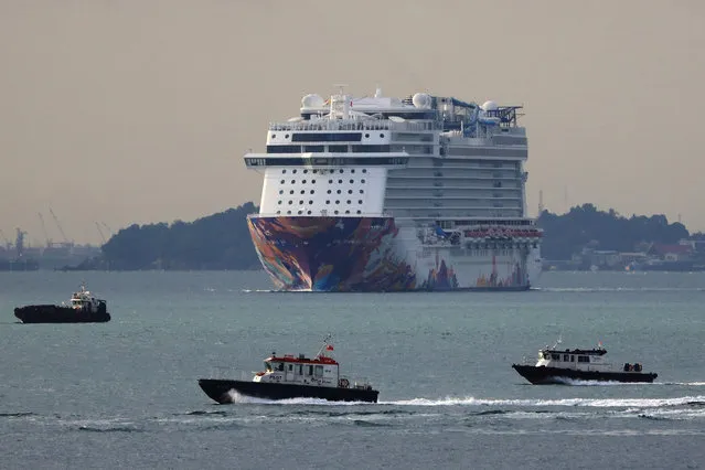 The World Dream cruise ship is seen returning to the port of call at the Marina Bay Cruise Centre on November 8, 2020 in Singapore. Genting's Dream Cruises, The World Dream vessel has been approved by the Singapore authorities to begin a pilot cruise to nowhere, for Singapore residents on November 6 amid the COVID-19 pandemic to give a much needed boost to the local tourism industry. (Photo by Suhaimi Abdullah/Getty Images)