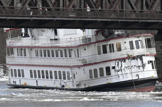 Captain JP III cruise ship is wedged against the Livingston Avenue train bridge that spans the Hudson River in Albany, N.Y., Friday, January 25, 2019. The unoccupied Hudson River cruise ship broke loose from its moorings amid rising water and ice jams, floated slowly downriver and is jammed under a rail bridge. (Photo by Hans Pennink/AP Photo)