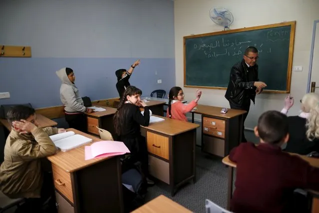 Blind and visually impaired Palestinian students attend a lesson at a school, where they are taught English through song and music, at a school in the West Bank city of Hebron March 2, 2016. (Photo by Ammar Awad/Reuters)