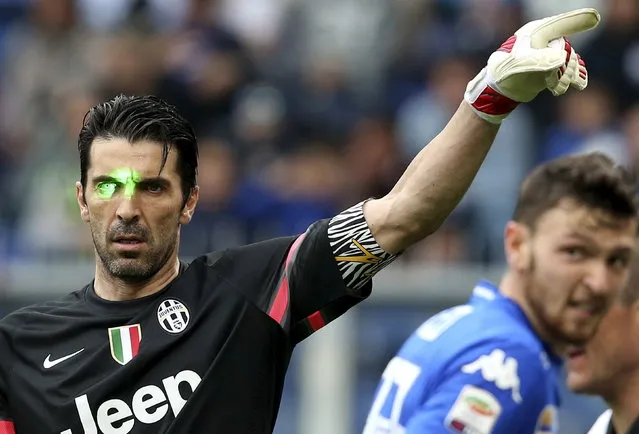 Juventus' Gianluigi Buffon is hit by lasers during their Serie A soccer match against Sampdoria at the Marassi stadium in Genoa, Italy, May 2, 2015. (Photo by Stefano Rellandini/Reuters)