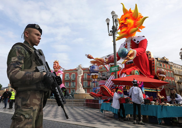 A French soldier stands guard before the start of the 133rd Nice carnival, the first major event since the city was attacked during Bastille Day celebrations last year, in Nice, France, February 11, 2017. (Photo by Eric Gaillard/Reuters)