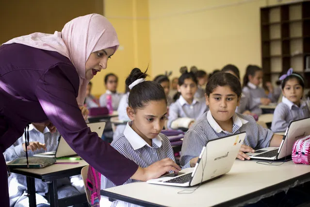In this Saturday, September 8, 2018 photo, Palestinian children use laptops at the Ziad Abu Ein School in the West Bank city of Ramallah. Palestinian educators are preparing for the future, hoping the use of technology and the arts will create new opportunities. It’s a revolution of sorts for the Palestinians, who like other Arab societies have long relied on schools that stress rote memorization and obedience over research, creativity and critical thinking. (Photo by Majdi Mohammed/AP Photo)