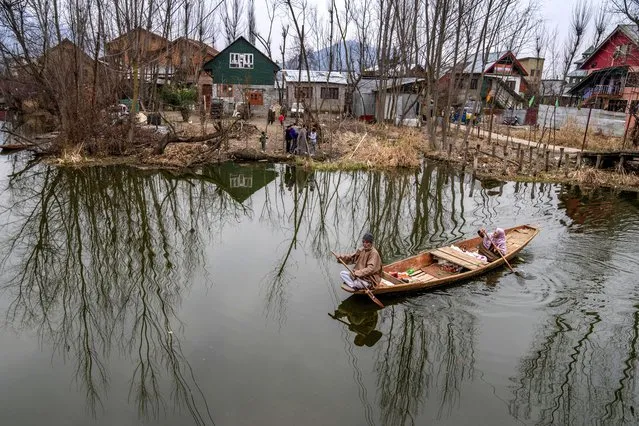 A couple on their way home after the day's work row a shikara, or traditional boat, in the interiors of the Dal Lake in Srinagar, Indian controlled Kashmir, Thursday, February 29, 2024. (Photo by Dar Yasin/AP Photo)