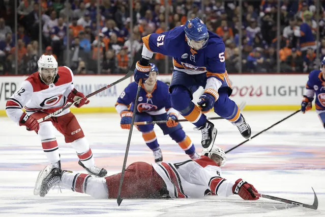 New York Islanders center Valtteri Filppula (51), of Finland, leaps over Carolina Hurricanes center Clark Bishop, bottom, while competing for the puck during the second period of Game 1 of an NHL hockey second-round playoff series, Friday, April 26, 2019, in New York. (Photo by Julio Cortez/AP Photo)