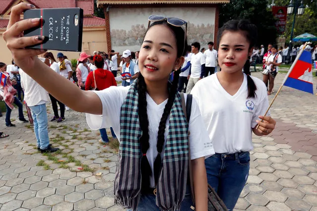 Cambodian workers take a photo during a rally in Phnom Penh, Cambodia, 01 May 2019. Workers and labor groups held a rally in the Cambodian capital to mark International Labor Day, calling on the Cambodian government to facilitate worker unions in the country. (Photo by Kith Serey/EPA/EFE)