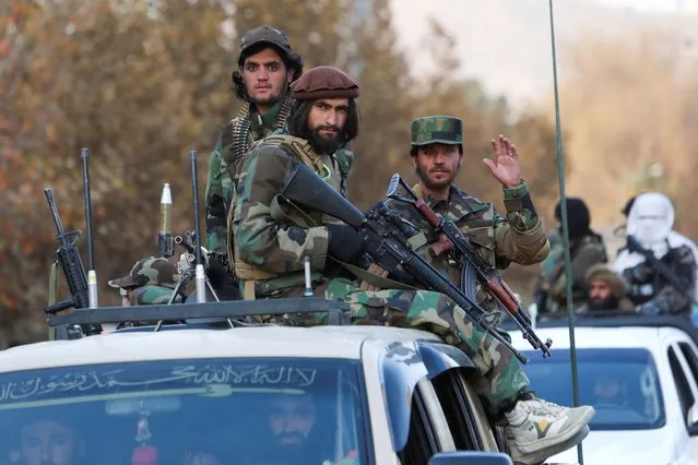 Members of Taliban sit on a military vehicle during Taliban military parade in Kabul, Afghanistan on November 14, 2021. (Photo by Ali Khara/Reuters)